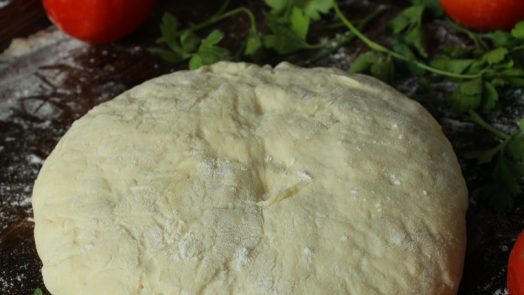 white dough on brown wooden table