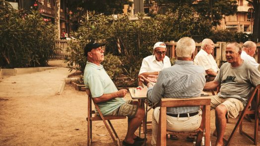 group of old men sitting near table