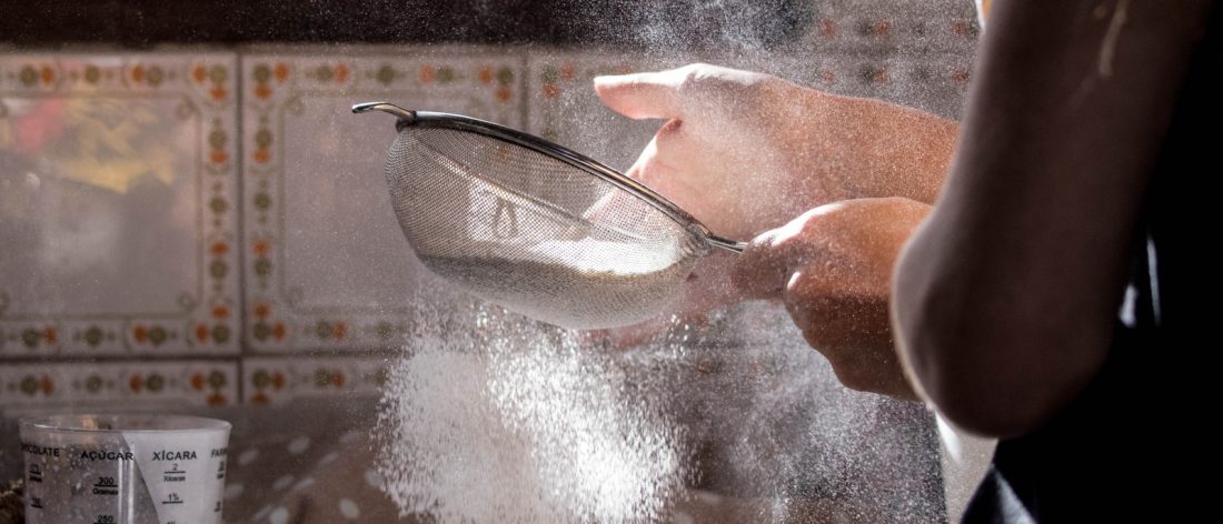 person pouring water on clear glass bowl