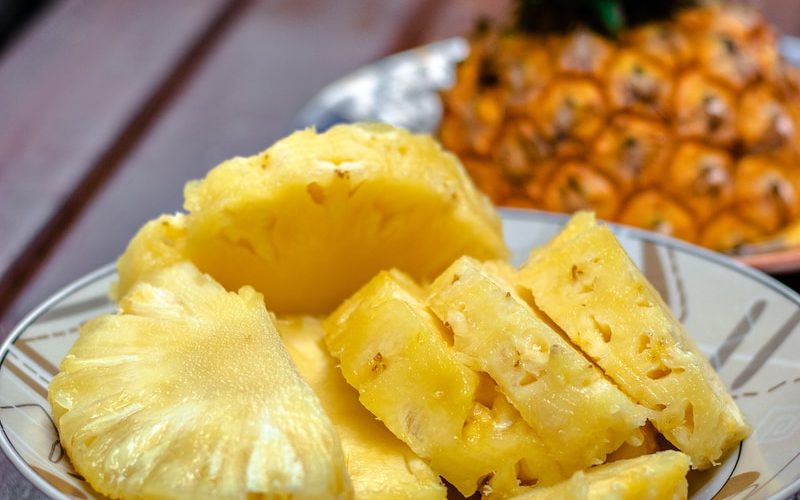 sliced pineapple on white ceramic plate